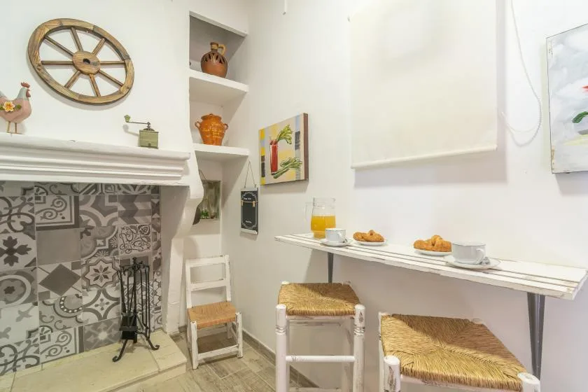 A bright dining nook with a small table set with drinks and pastries.