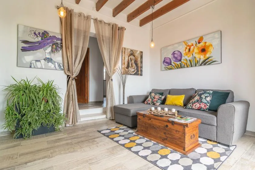 A living room with a gray sectional and a wooden coffee table.