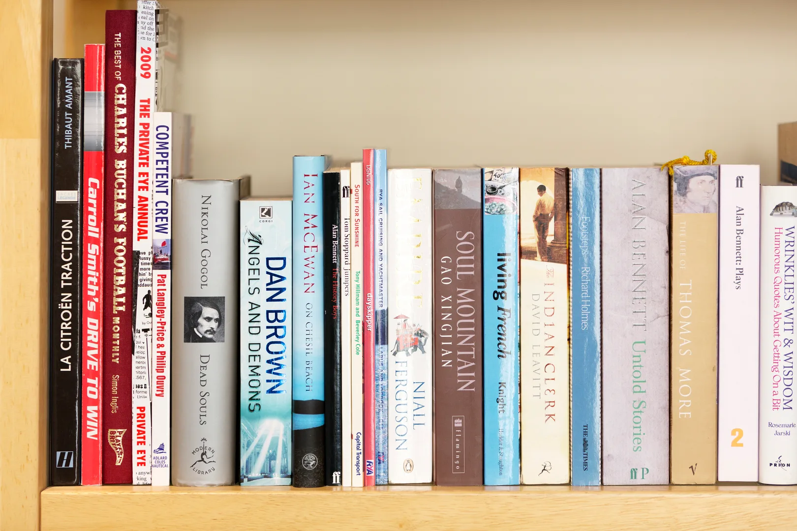 A bookshelf lined with books of varied colors and sizes.