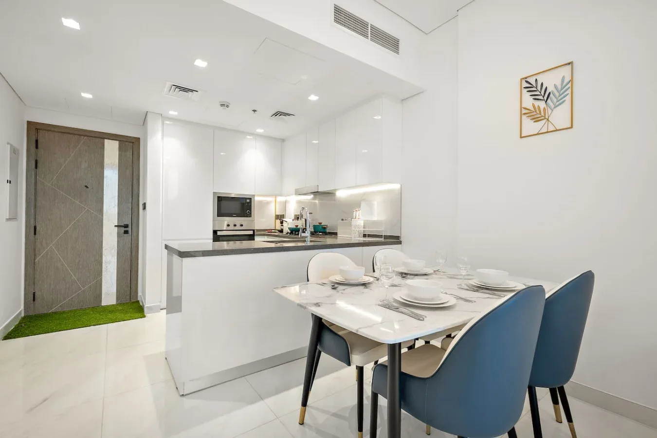 A bright kitchen and dining area with a table set beside the counter.