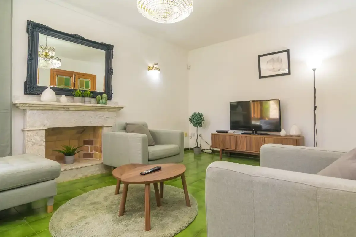 Una sala de estar con asientos, una chimenea y un televisor.