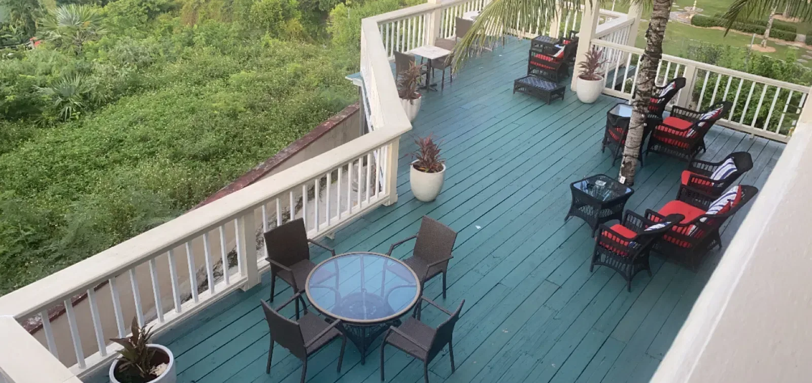Terraza elevada con sillas y mesas con vistas a la vegetación