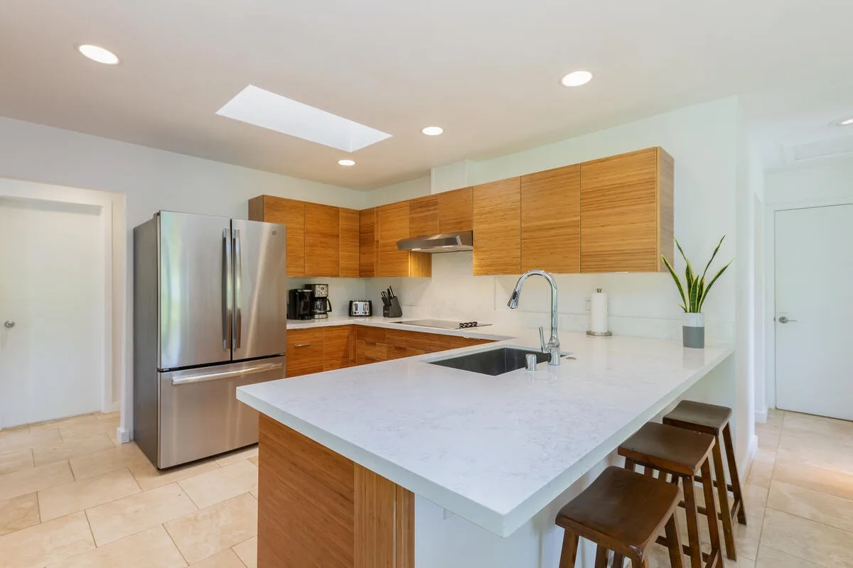 A bright modern kitchen with wooden cabinets and a large island.