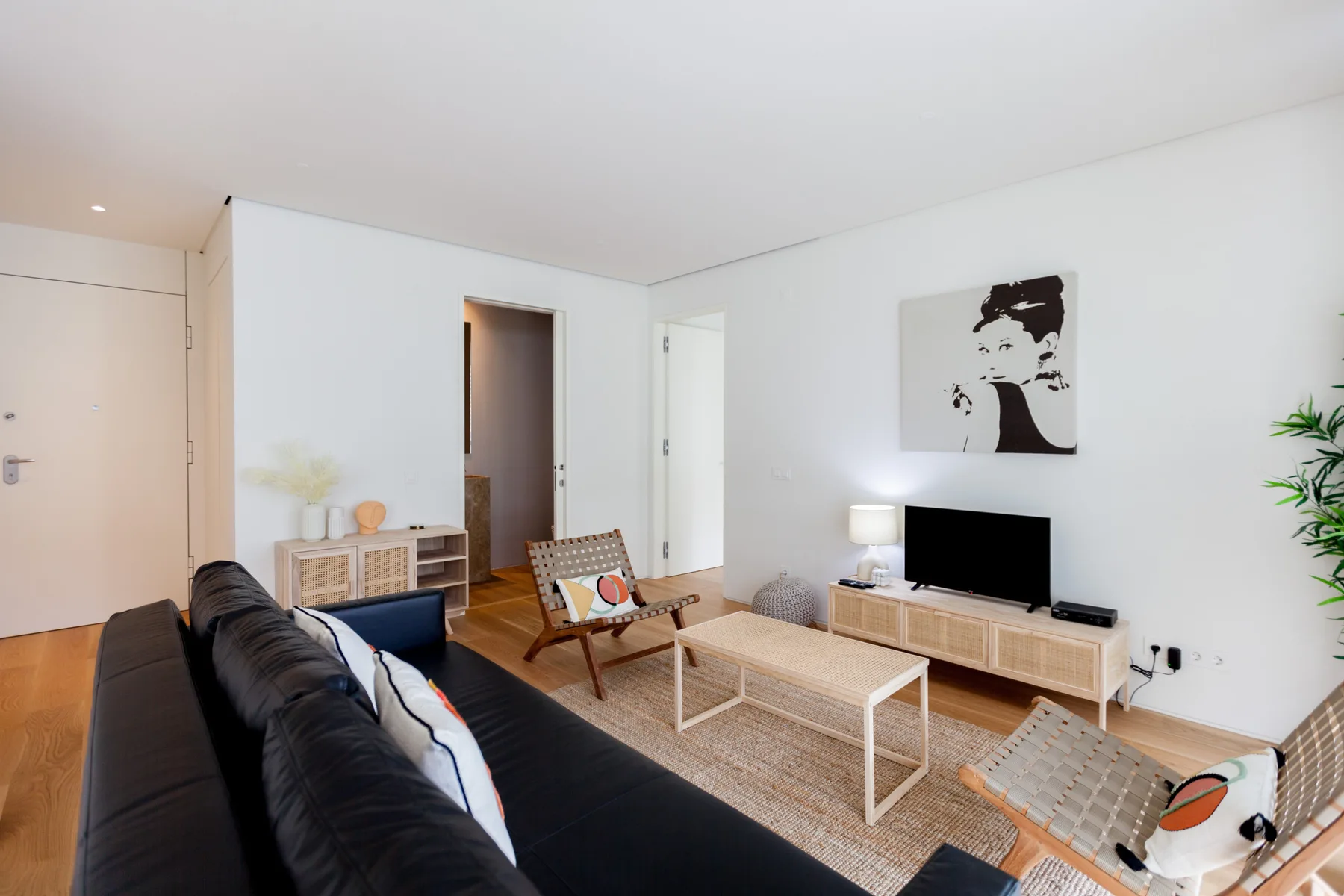 A living room with a television, coffee table, and seating.