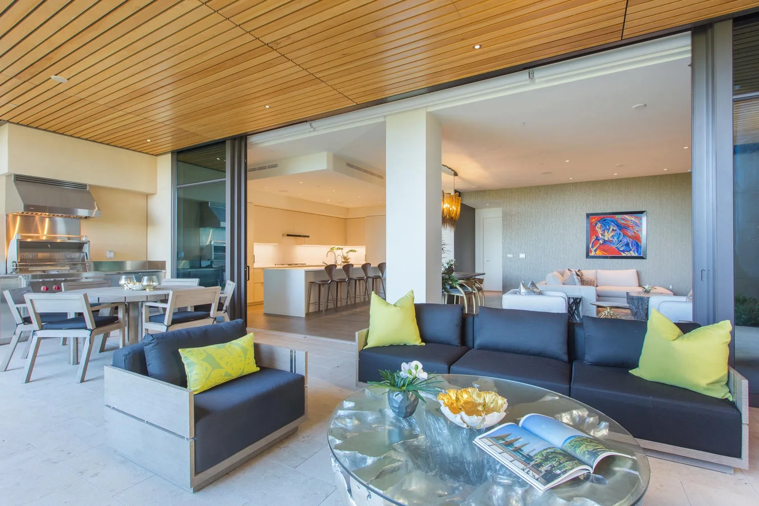 An open-plan living and dining area with seating beside a kitchen.