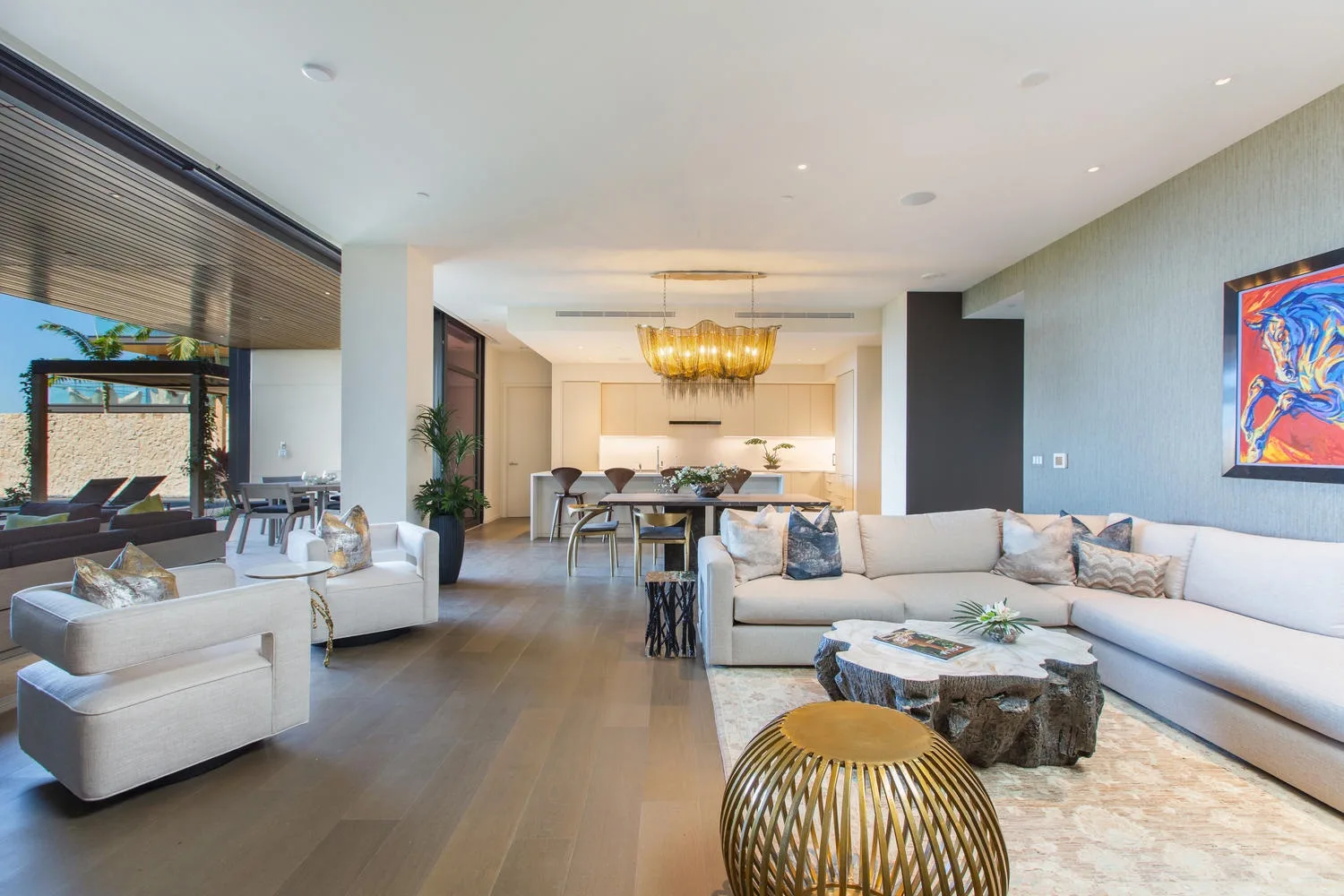 A spacious living room with seating, a coffee table, and a dining area.