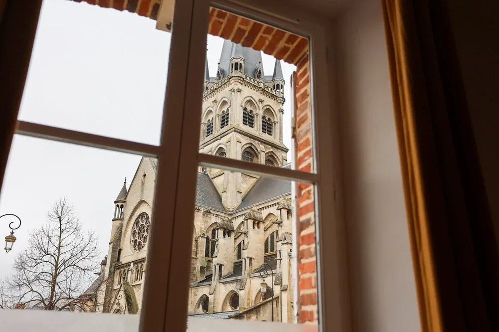 A historic stone church tower is visible through a window.