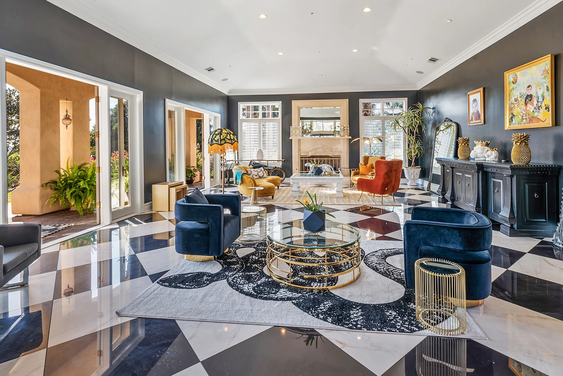 A spacious living room with seating arranged around a glass coffee table.