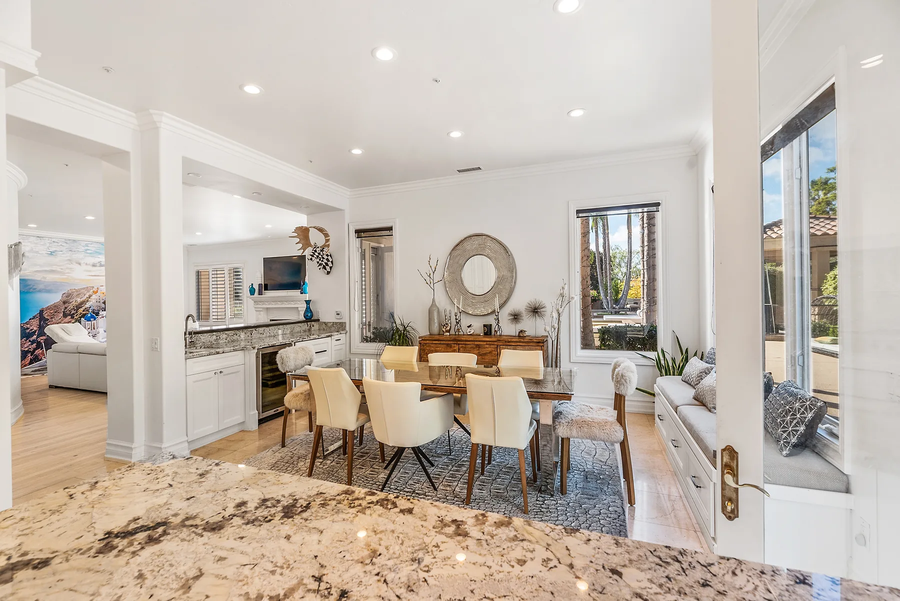 A bright open dining and kitchen area with a table and countertop.