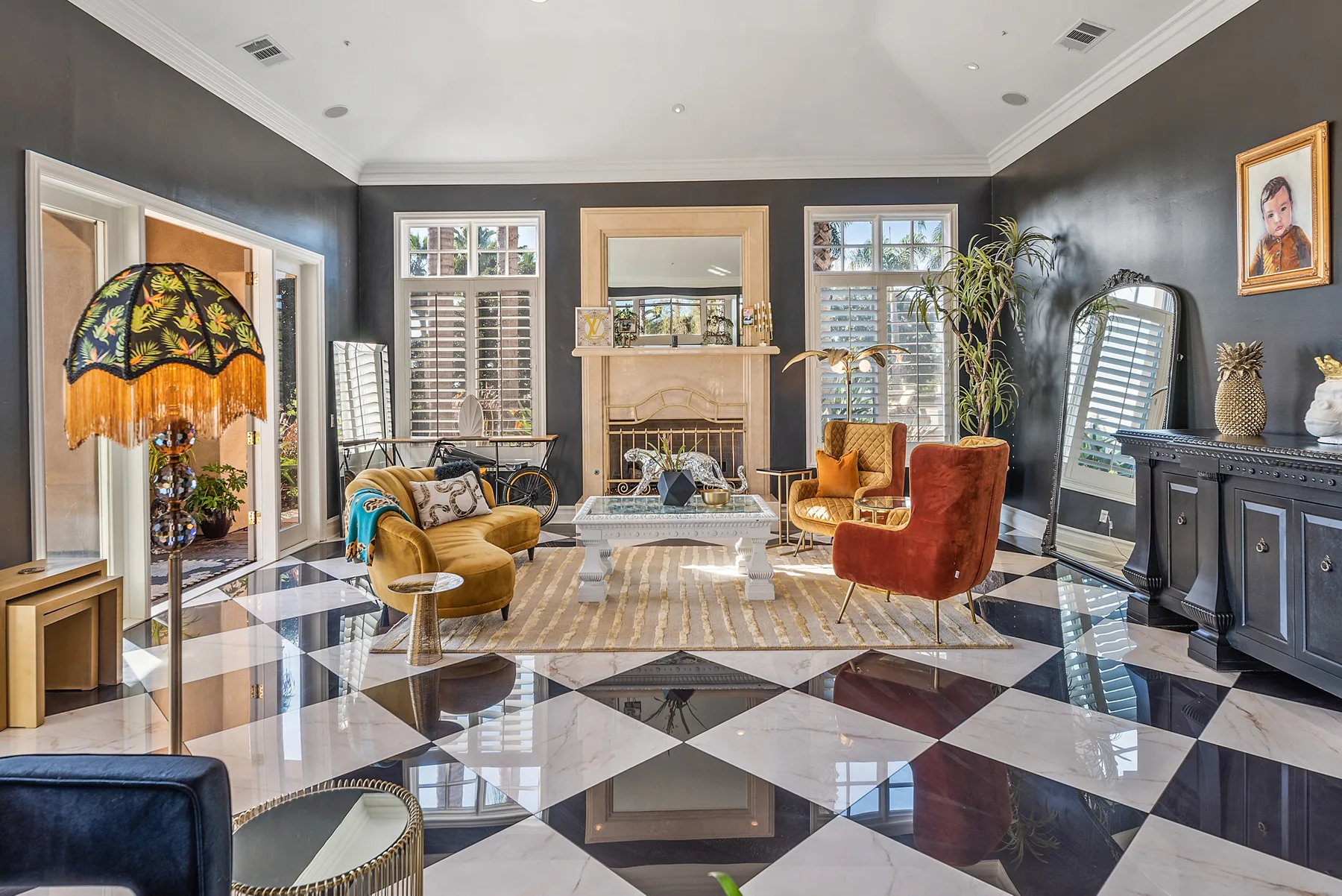 A bright living room with seating around a fireplace and a patterned tile floor.