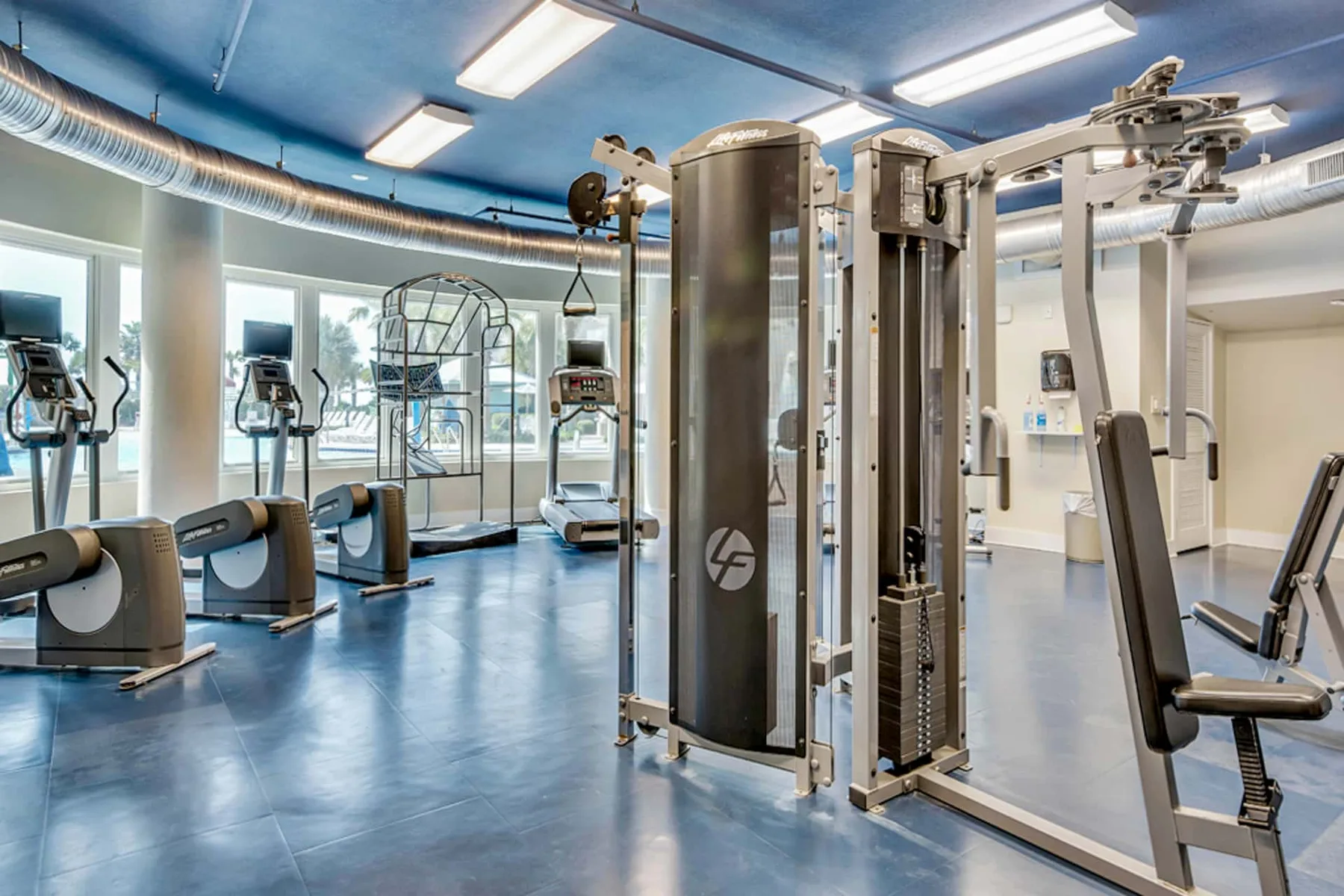 A gym with cardio machines and weight-training equipment.