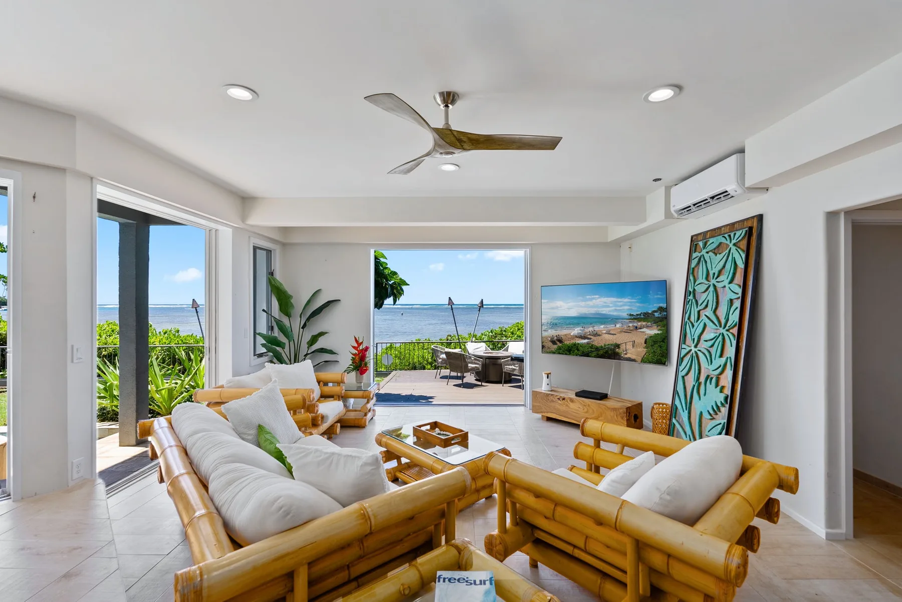A bright living room opens onto a patio with ocean views.