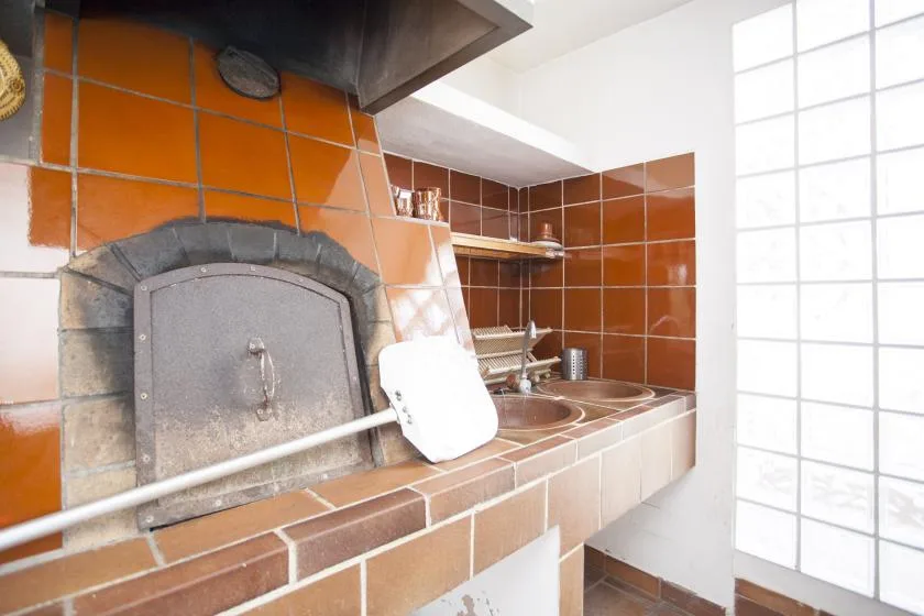 A tiled kitchen cooking area with a built-in oven and counter.