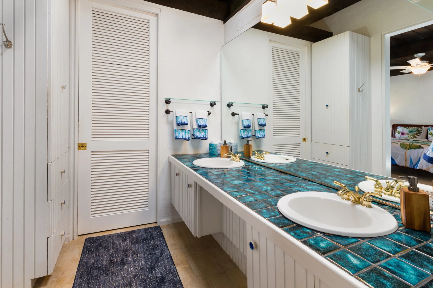 A bathroom vanity with two sinks and a large wall mirror.