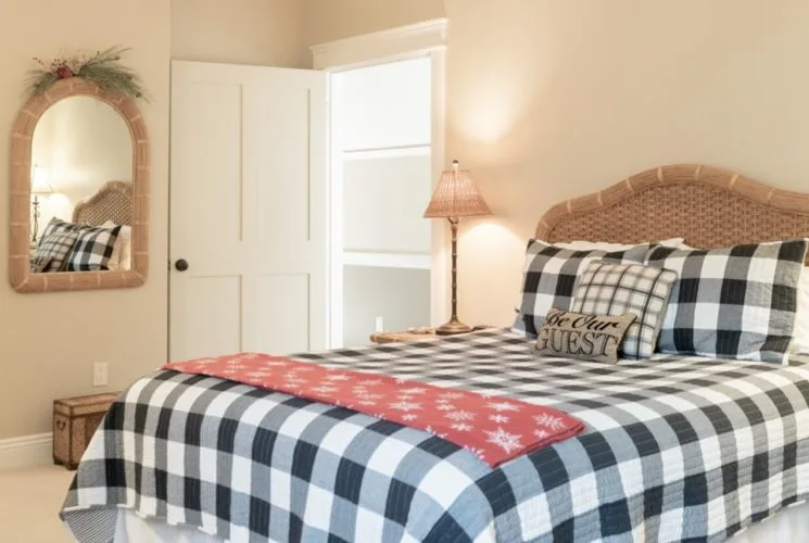 Bedroom with a queen bed and black-and-white check quilt