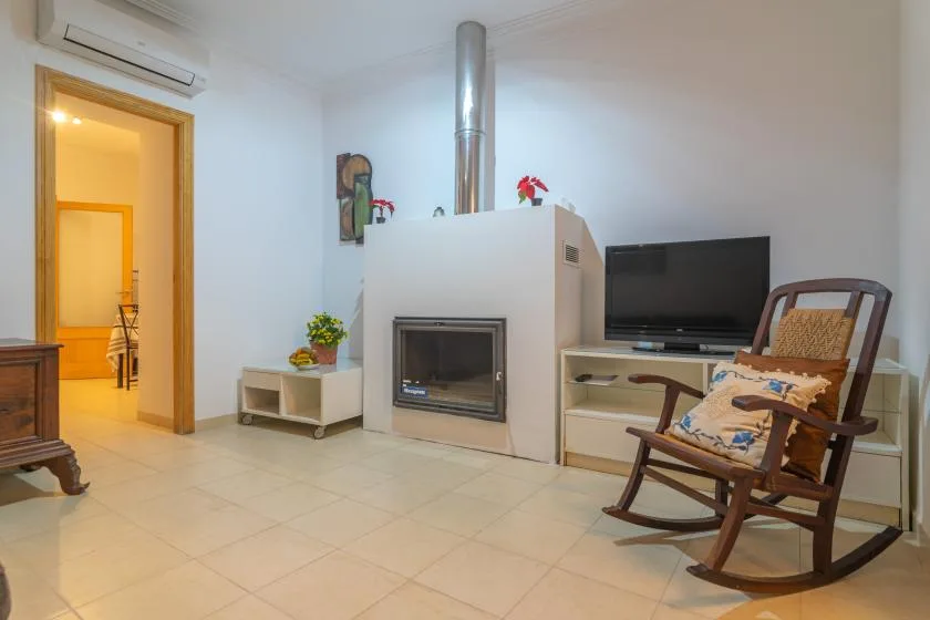 A living room with a fireplace, television, and seating.