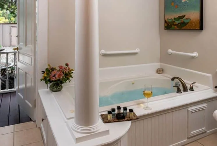 Bathroom with tiled flooring and jetted tub