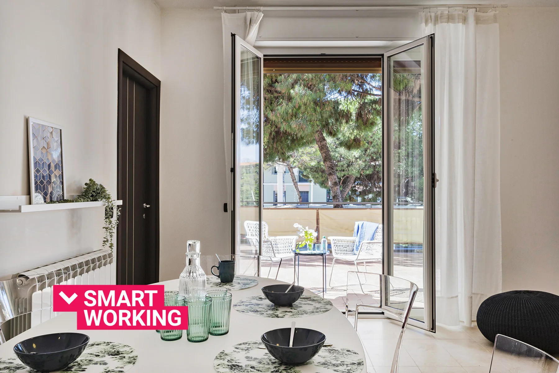 A bright dining area opens onto a patio through wide glass doors.
