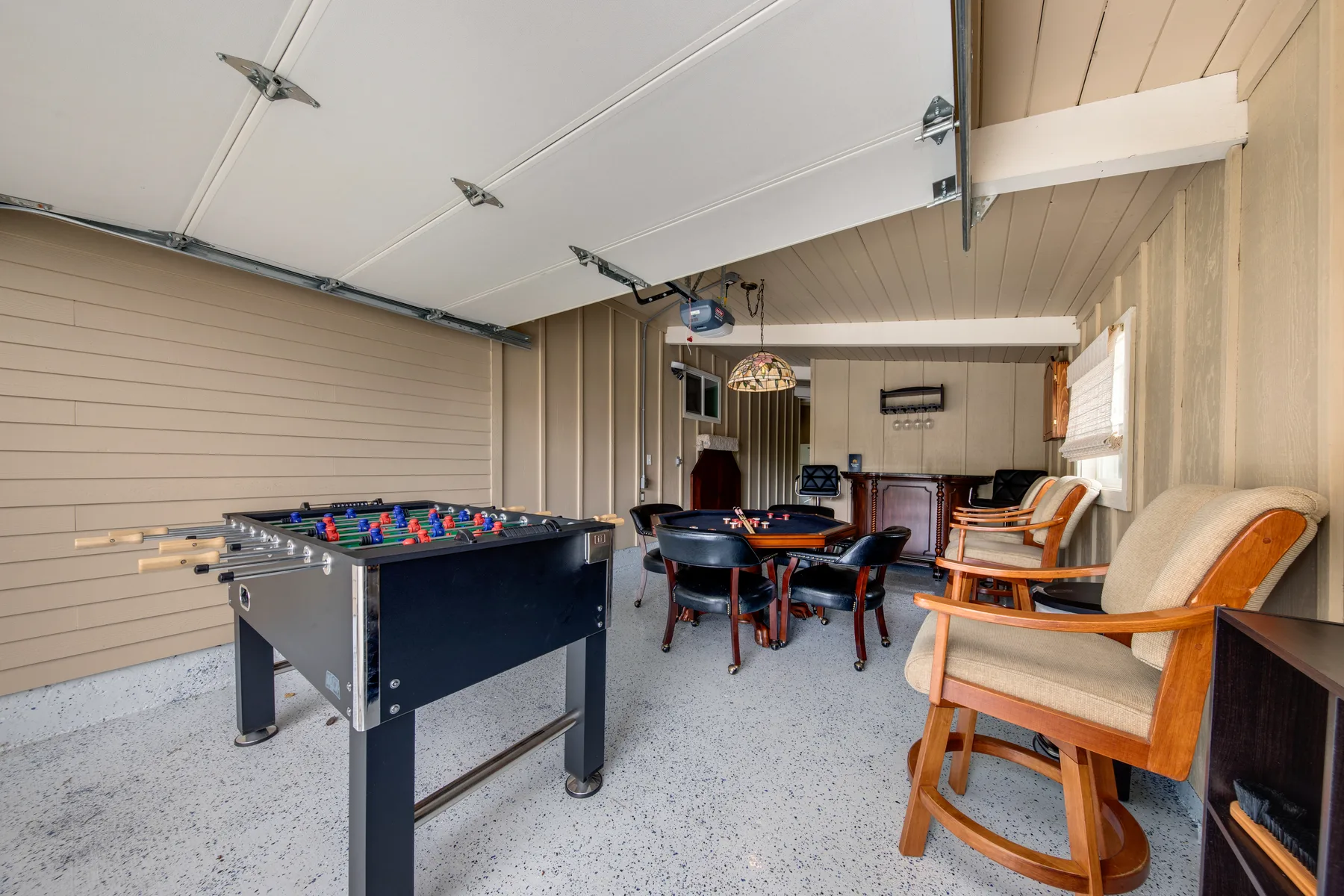 A game room features a foosball table and seating.