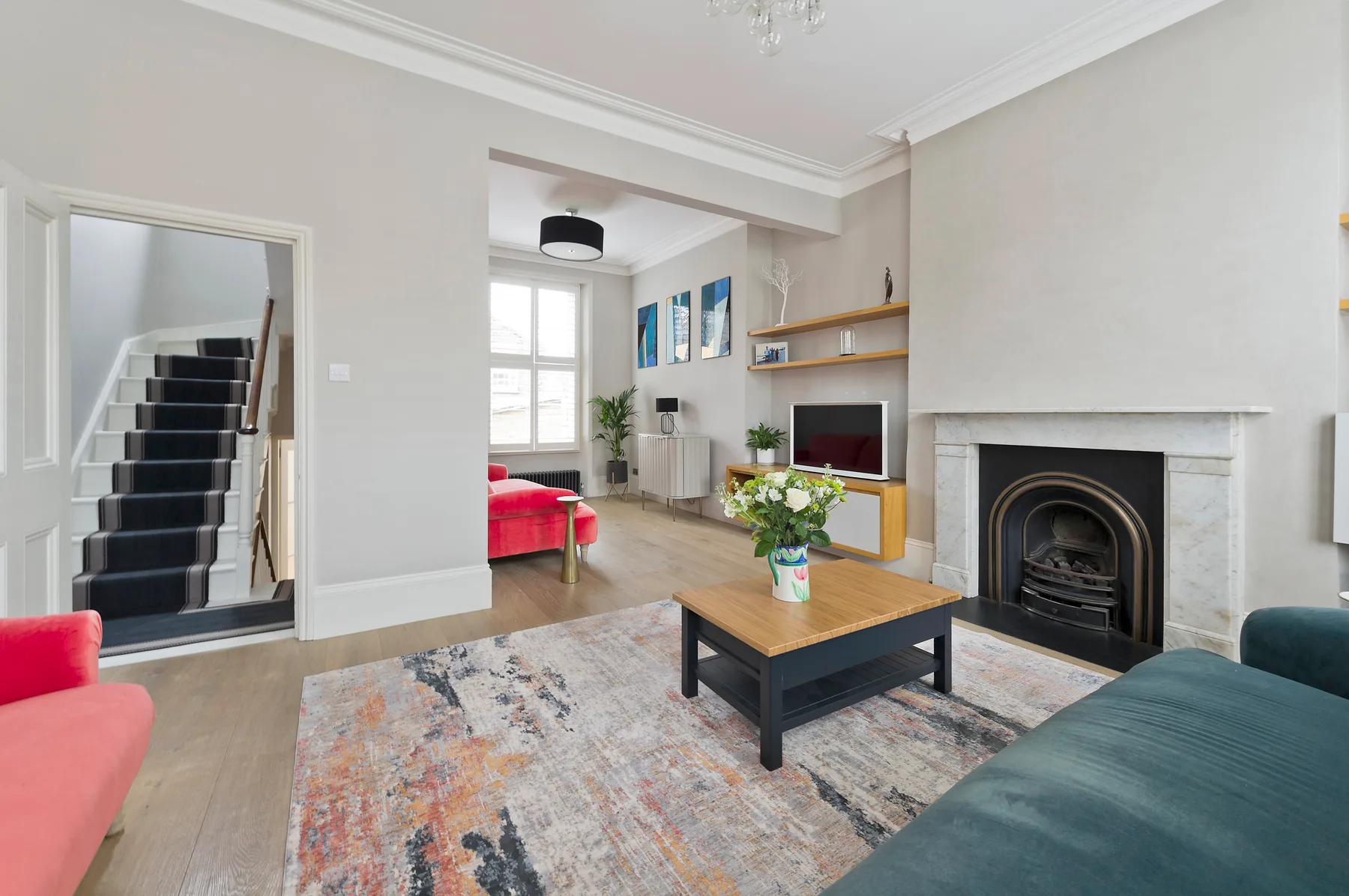 A living room with a fireplace, television, and seating around a coffee table.
