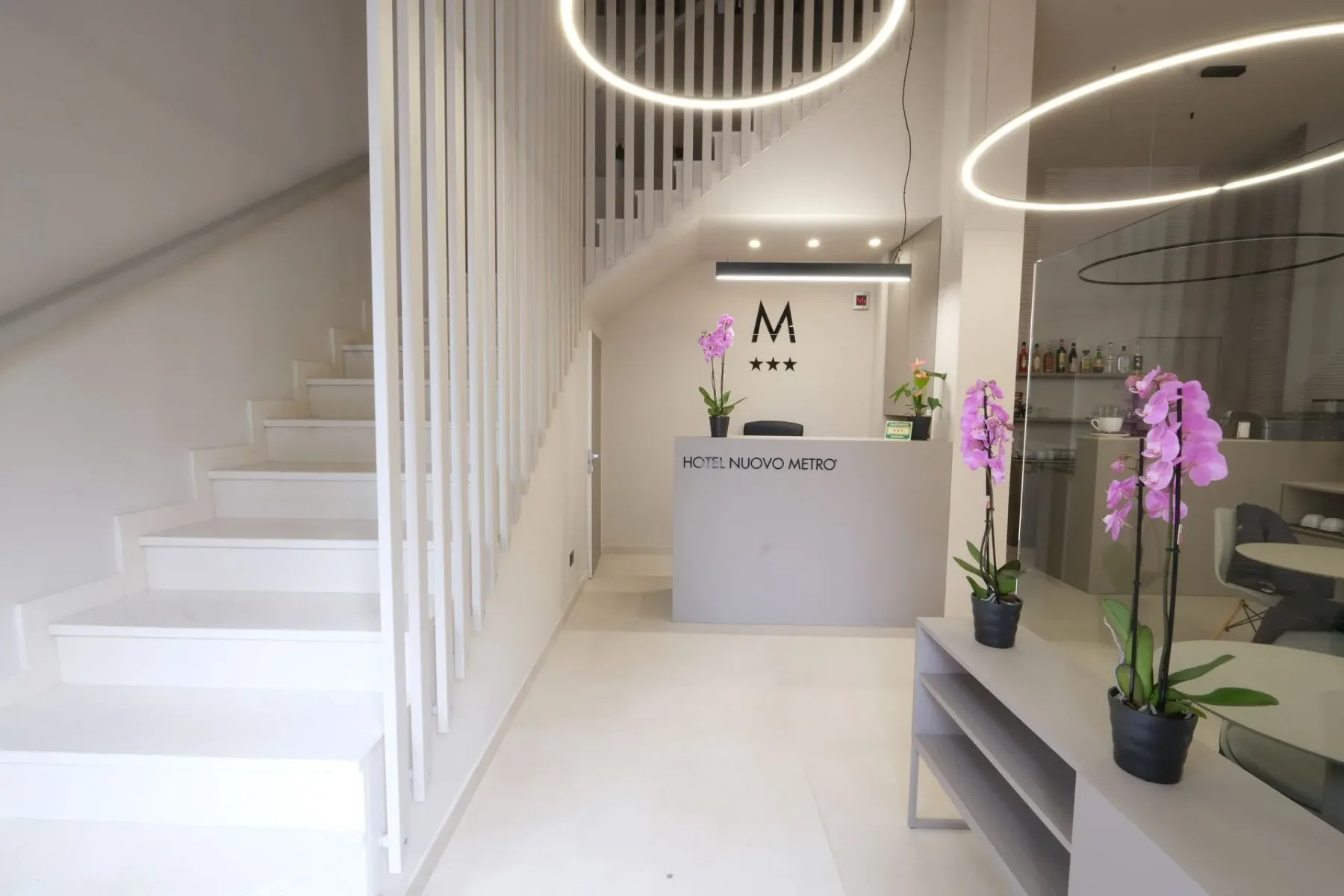 Vestíbulo del hotel con escaleras y recepción.