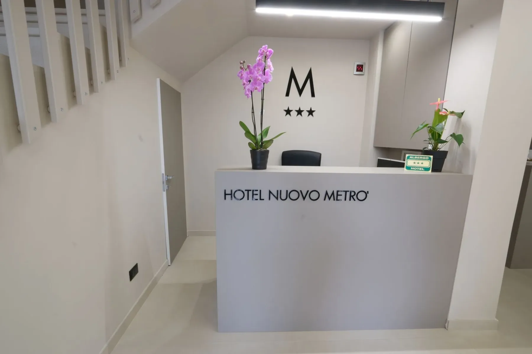 Hotel reception with a purple flower.