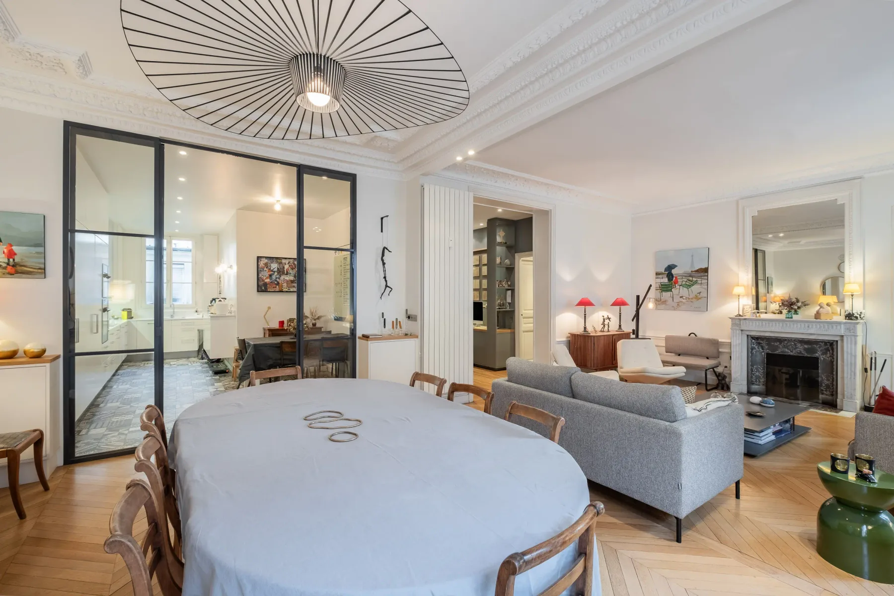 A bright living and dining room with a large table and seating.