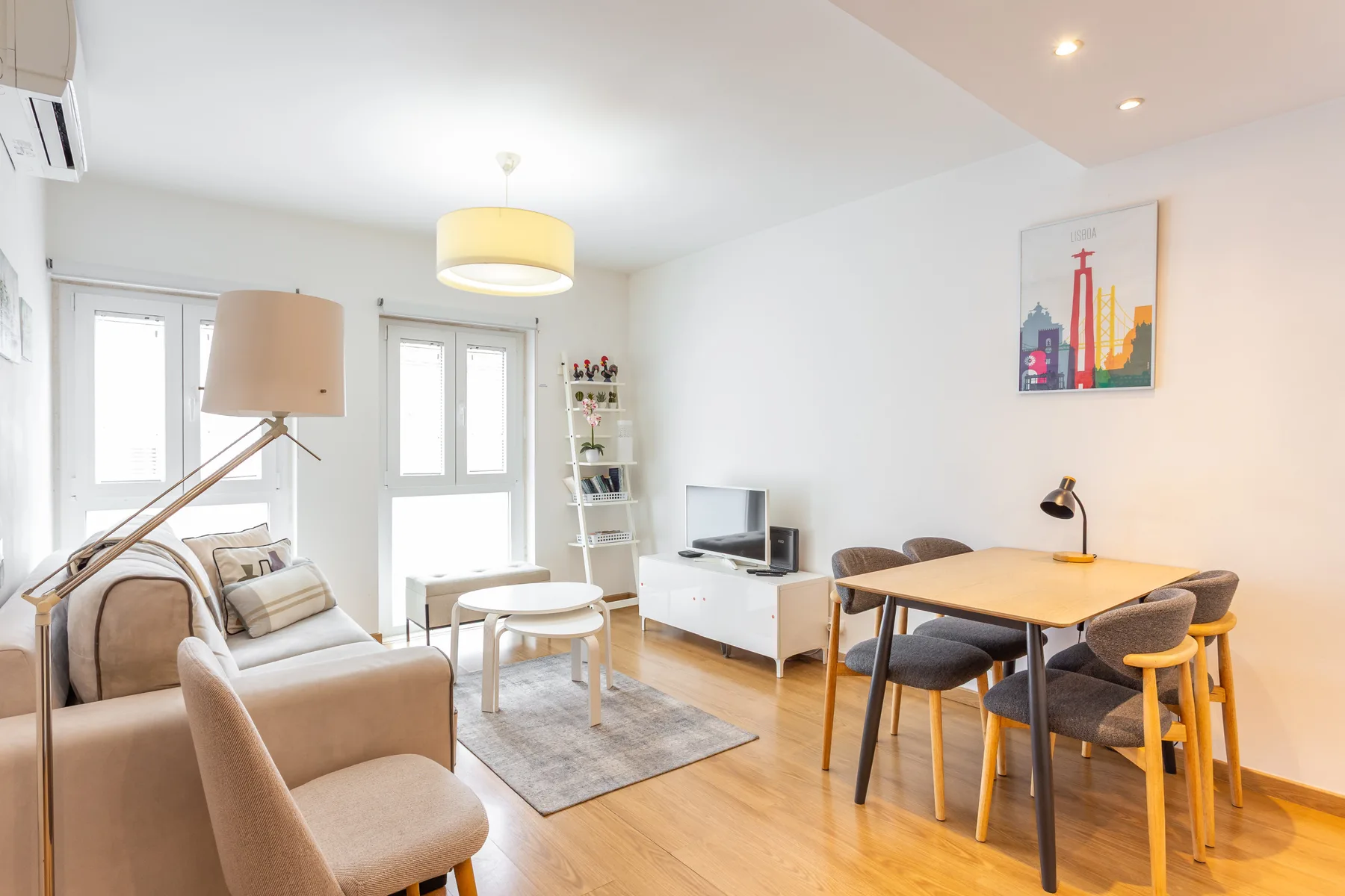 A bright living and dining area with seating, a coffee table, and a dining table.