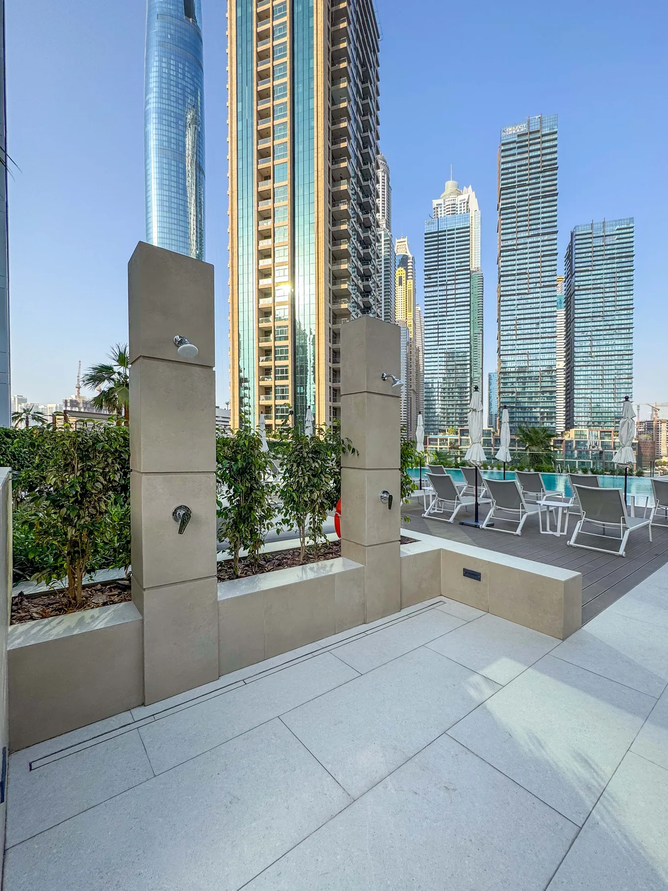 Una terraza en la azotea con asientos al aire libre y altos edificios al fondo.