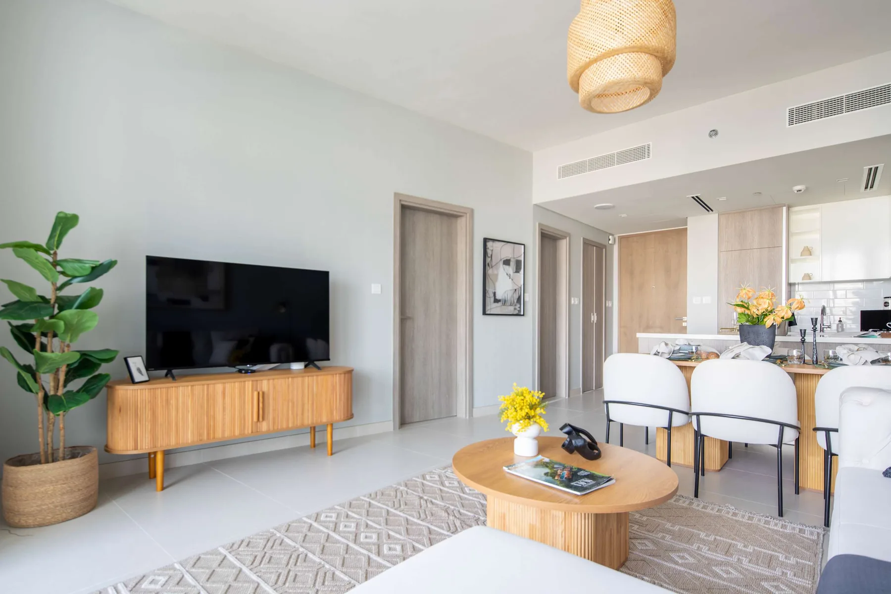 A bright living room opens into a dining area and kitchen.