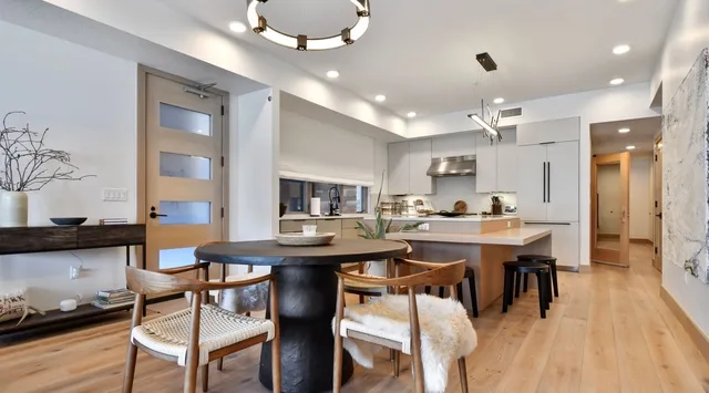 An open-plan kitchen and dining area with a central island and dining table.