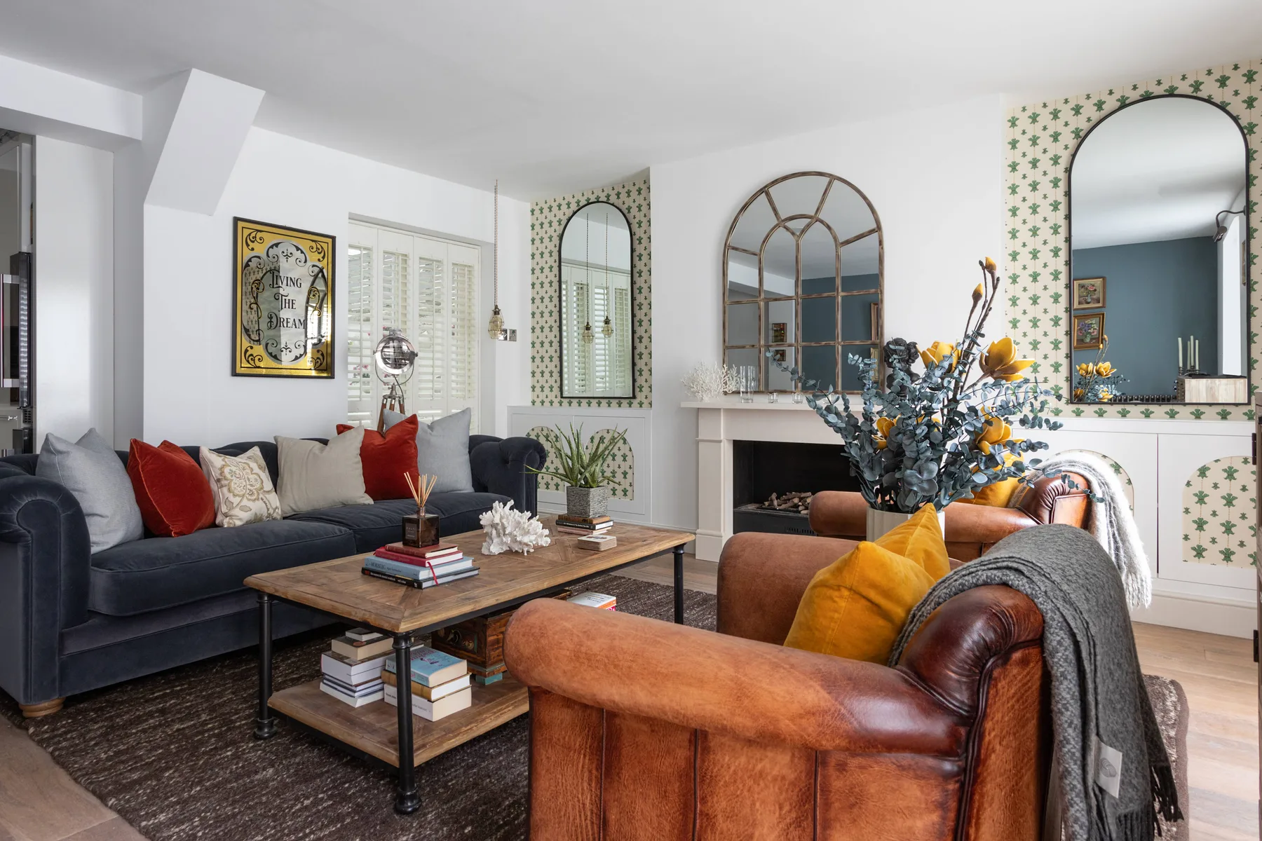 A bright living room with seating arranged around a wooden coffee table.