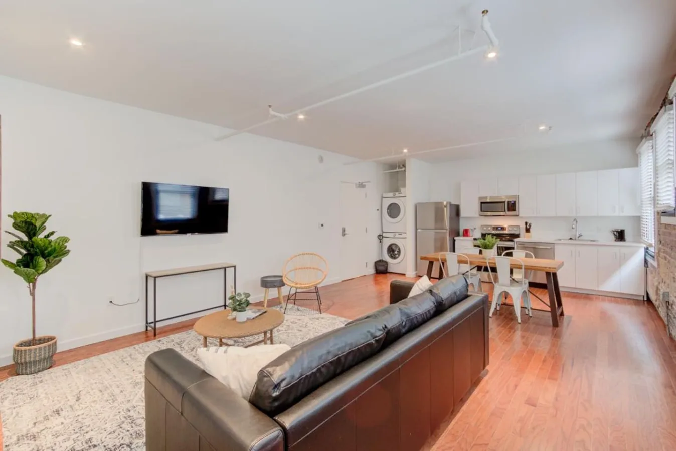 An open-plan living and kitchen area with seating and a dining table.
