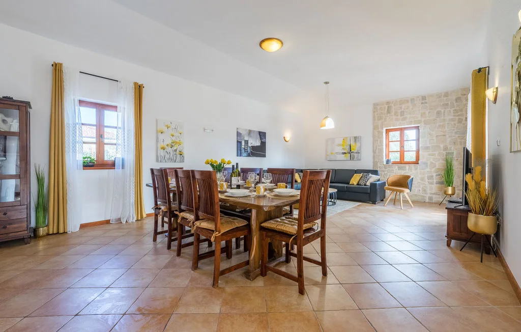 A spacious dining and living area with a wooden table and seating.