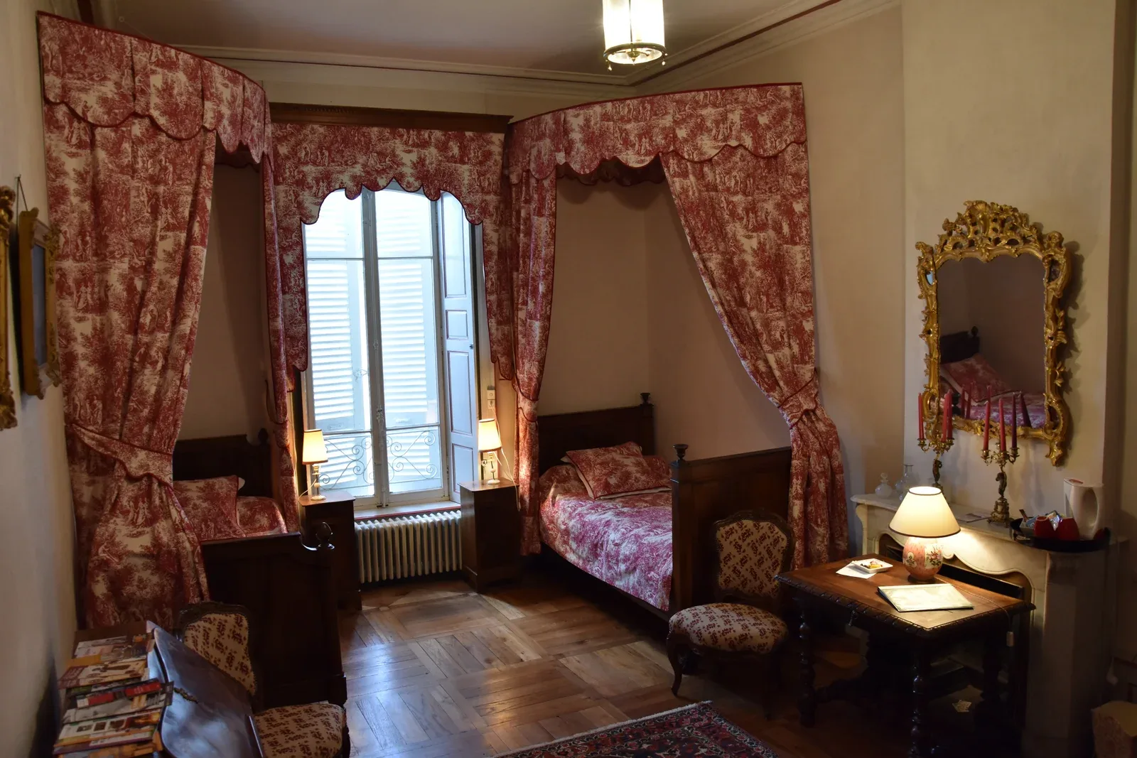 Tante Marie room with red Toile de Jouy canopy beds