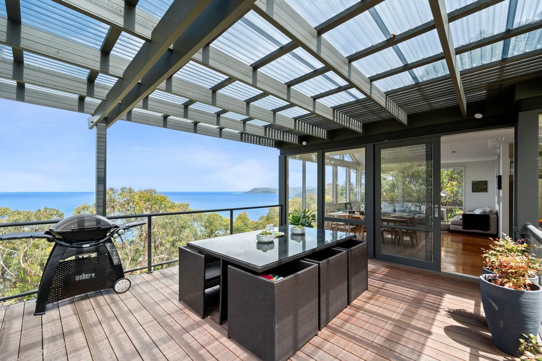 A covered outdoor dining area overlooks the ocean.