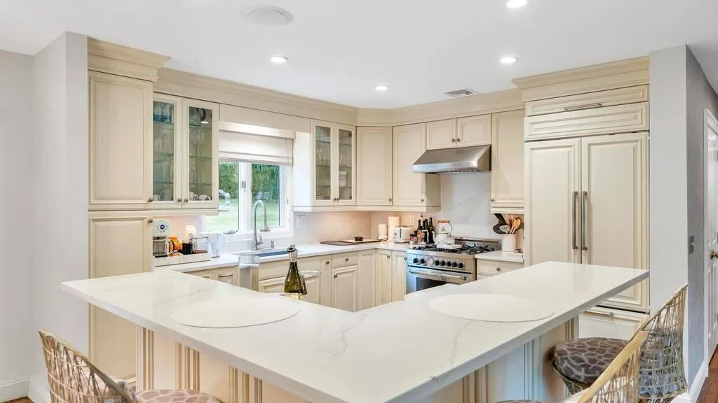 A bright kitchen with pale cabinetry and a large central island.