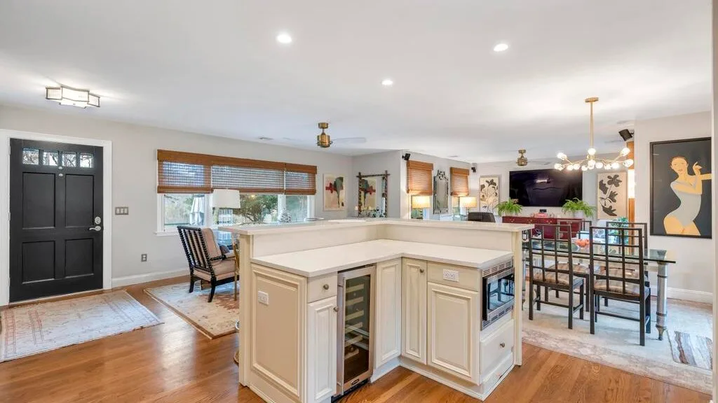 An open-plan kitchen and dining area with a large island and table seating.