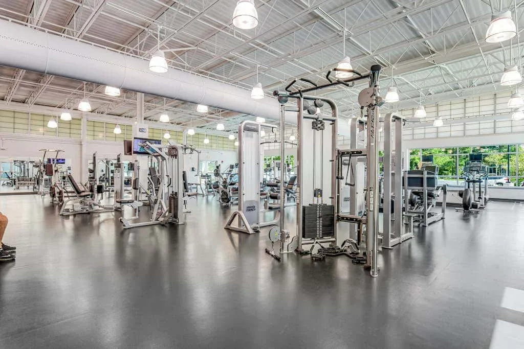 A spacious gym with weight machines and exercise equipment.