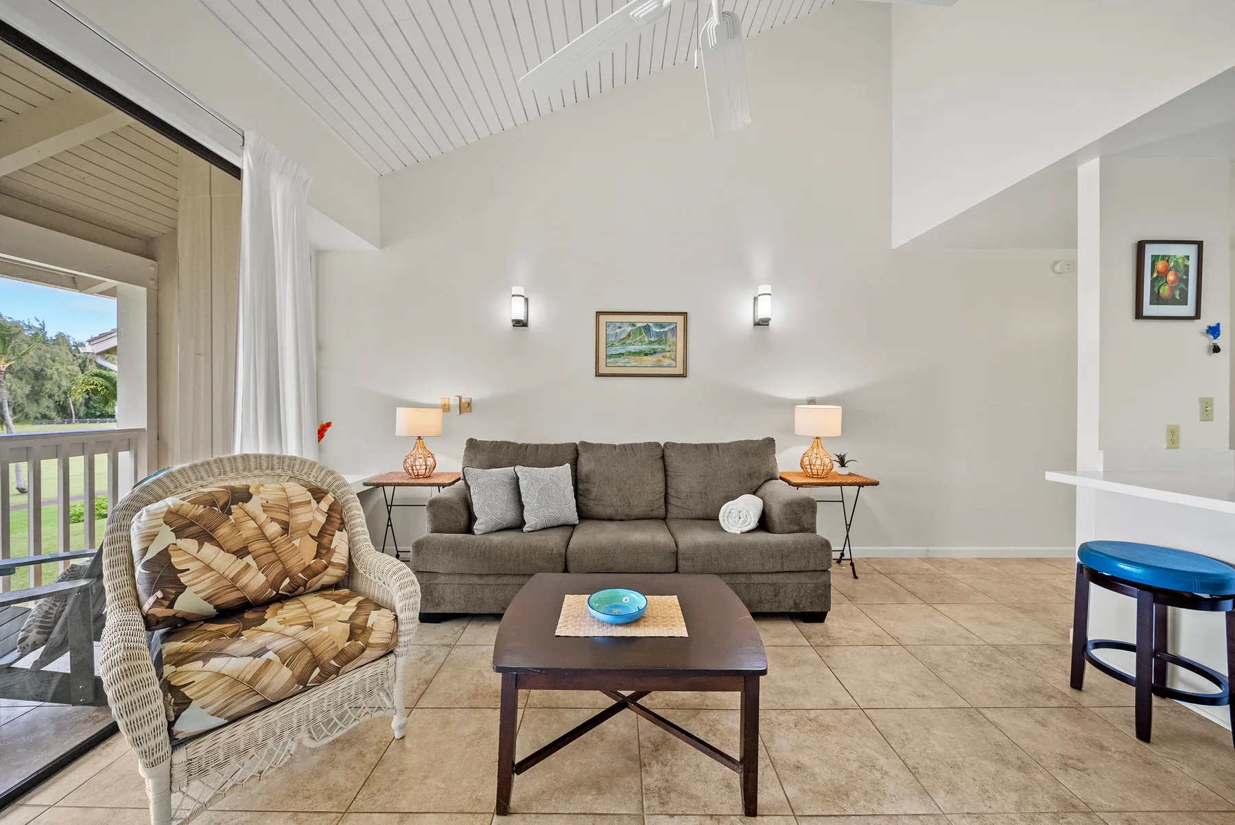 Living room with a gray seating area, coffee table, and sliding glass door.