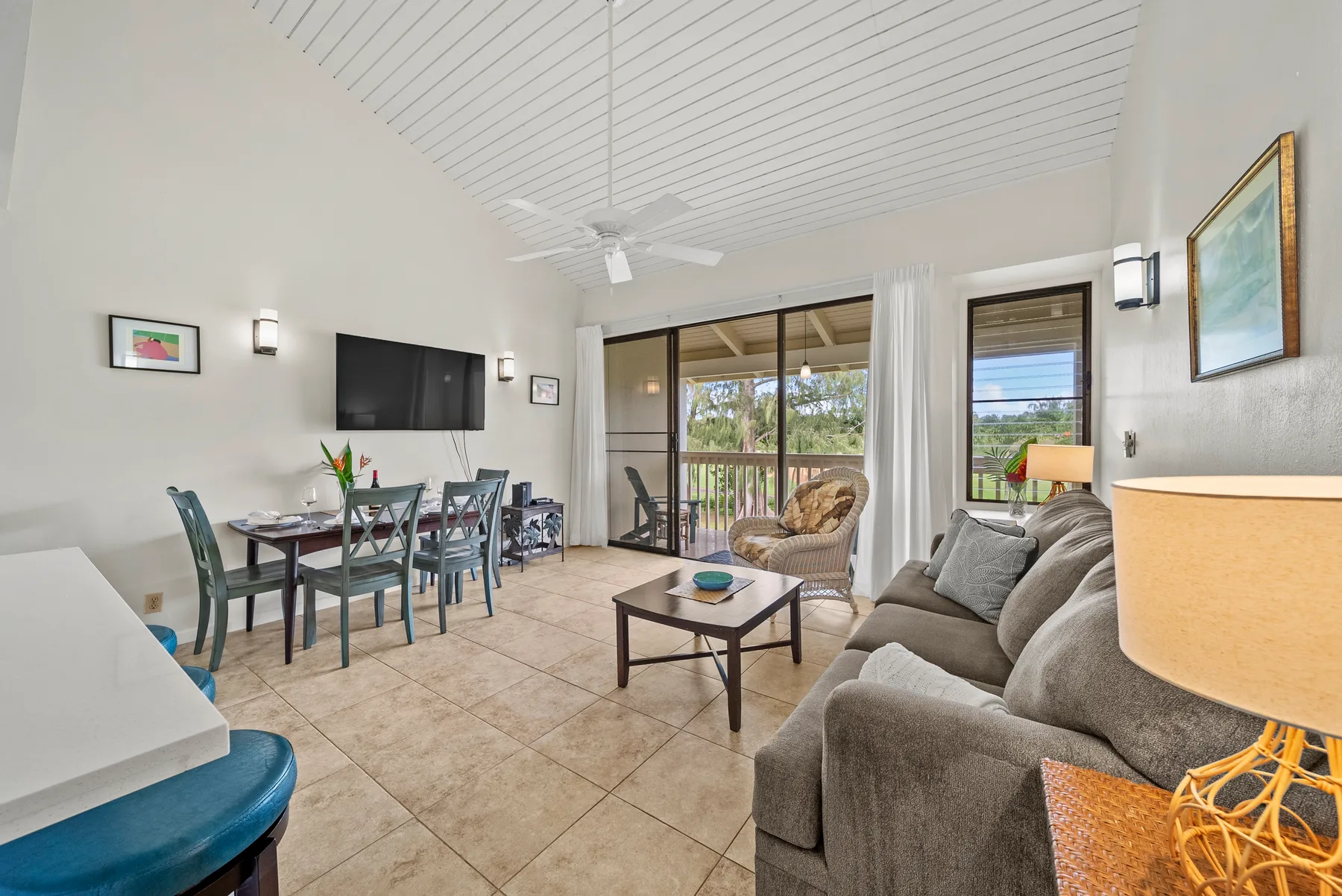 Living room with seating, a coffee table, and sliding glass doors opening to a balcony.