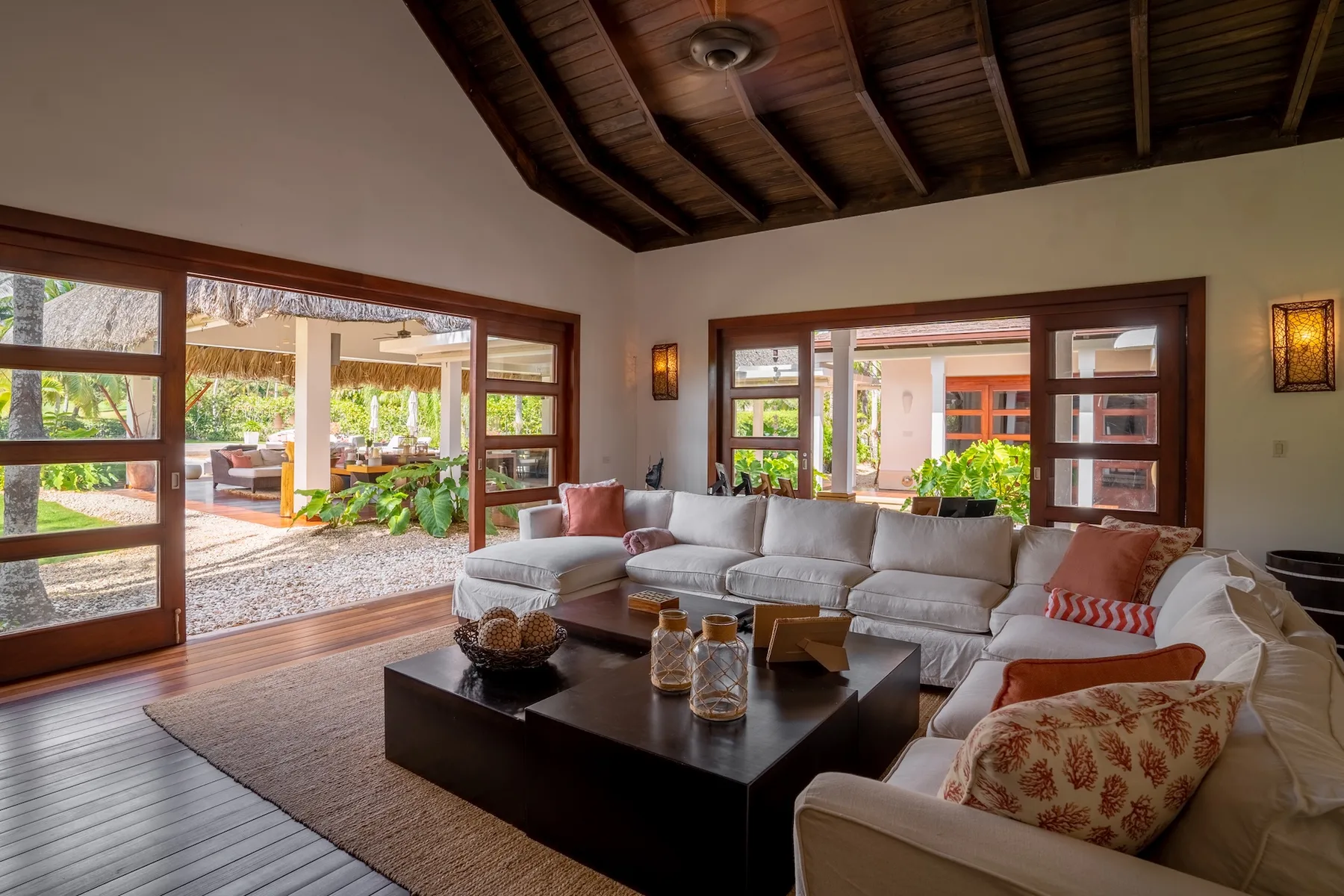A living room with a sectional seating area and a dark coffee table.