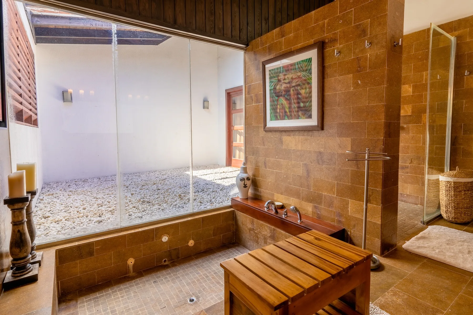 A bathroom with a large bathtub, tiled walls, and a wooden table.