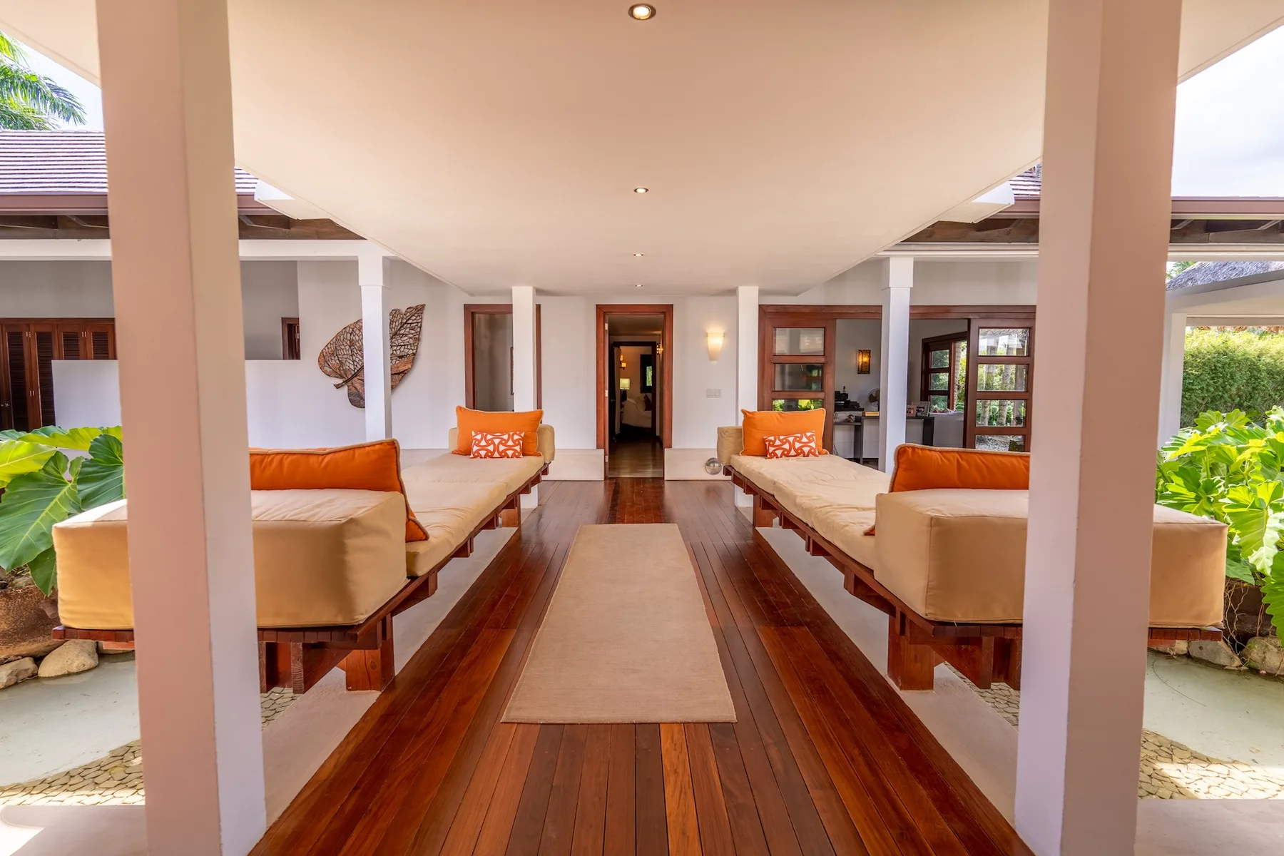 A bright lounge with seating arranged along a polished wooden floor.