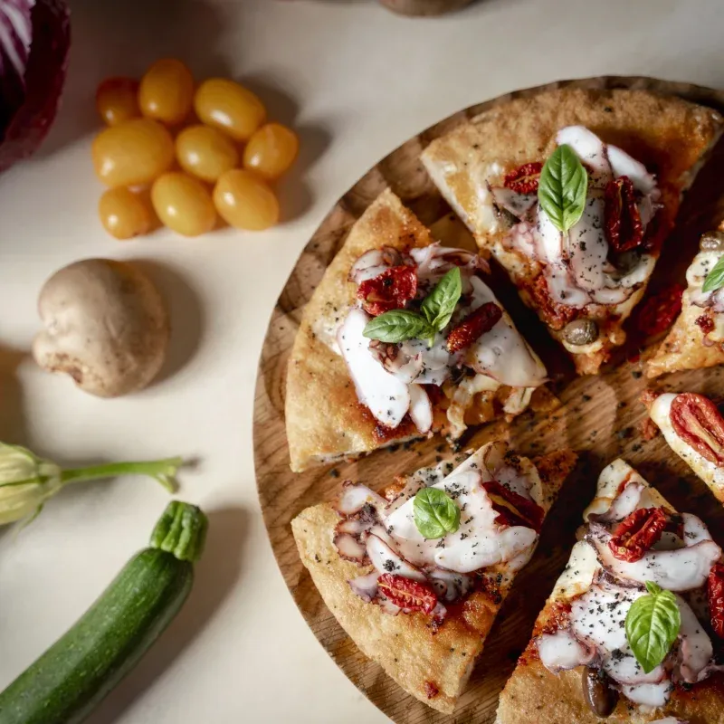 Pizza topped with basil.