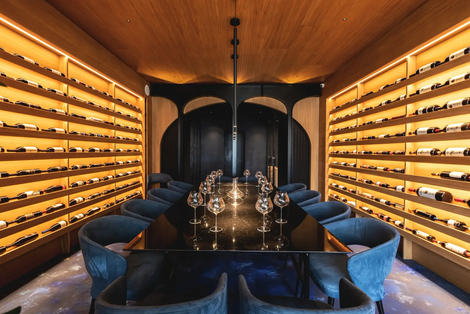 Wine cellar dining room with bottle racks.
