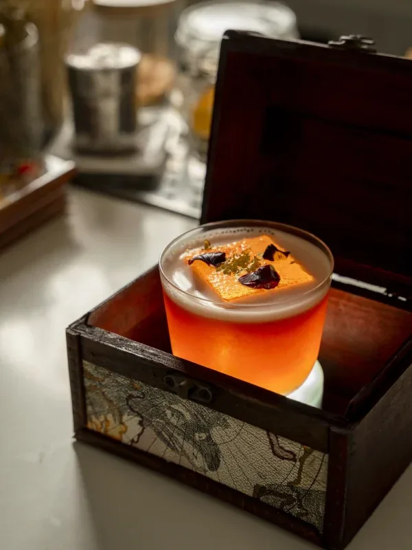 Cocktail served in a decorative wooden box.