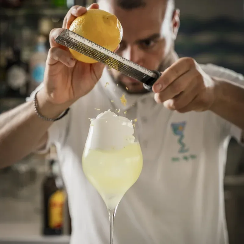 Bartender garnishing a cocktail.