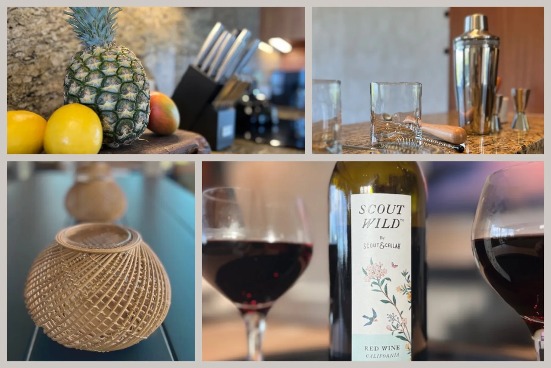 A kitchen counter displays fresh fruit, cocktail glasses, and a bottle of red wine.