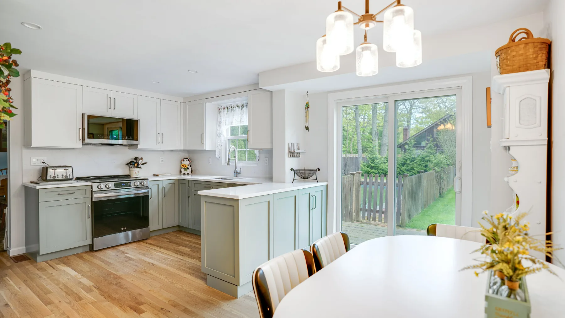 A bright kitchen and dining area with an island and sliding glass doors.